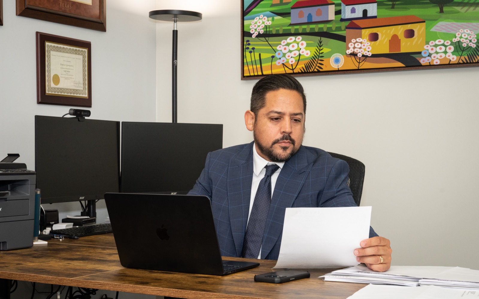Daniel reviewing documents at his desk